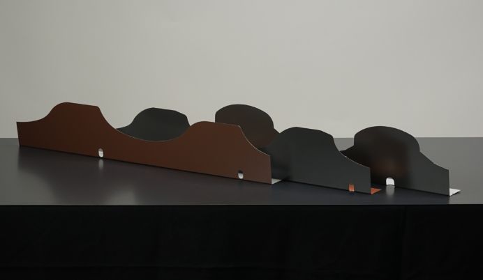 A row of wooden benches on top of a table.