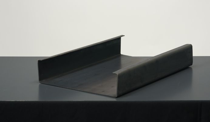 A black metal object sitting on top of a table.