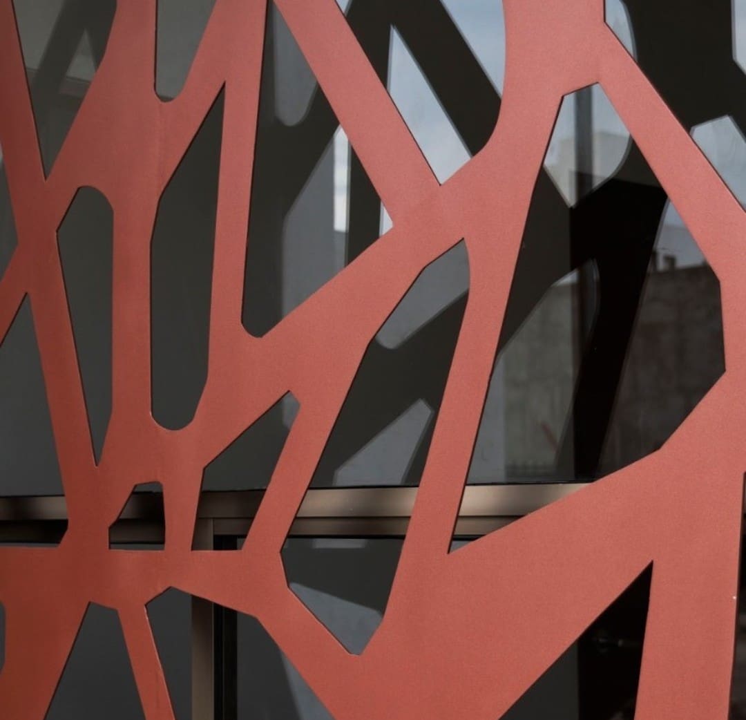 A close up of the red spider web on a wall