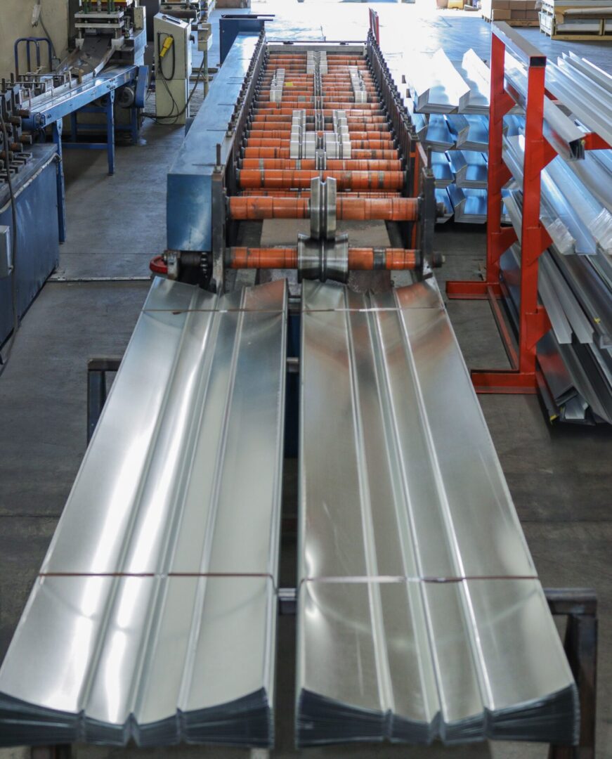 A conveyor belt with metal rails and orange handles.