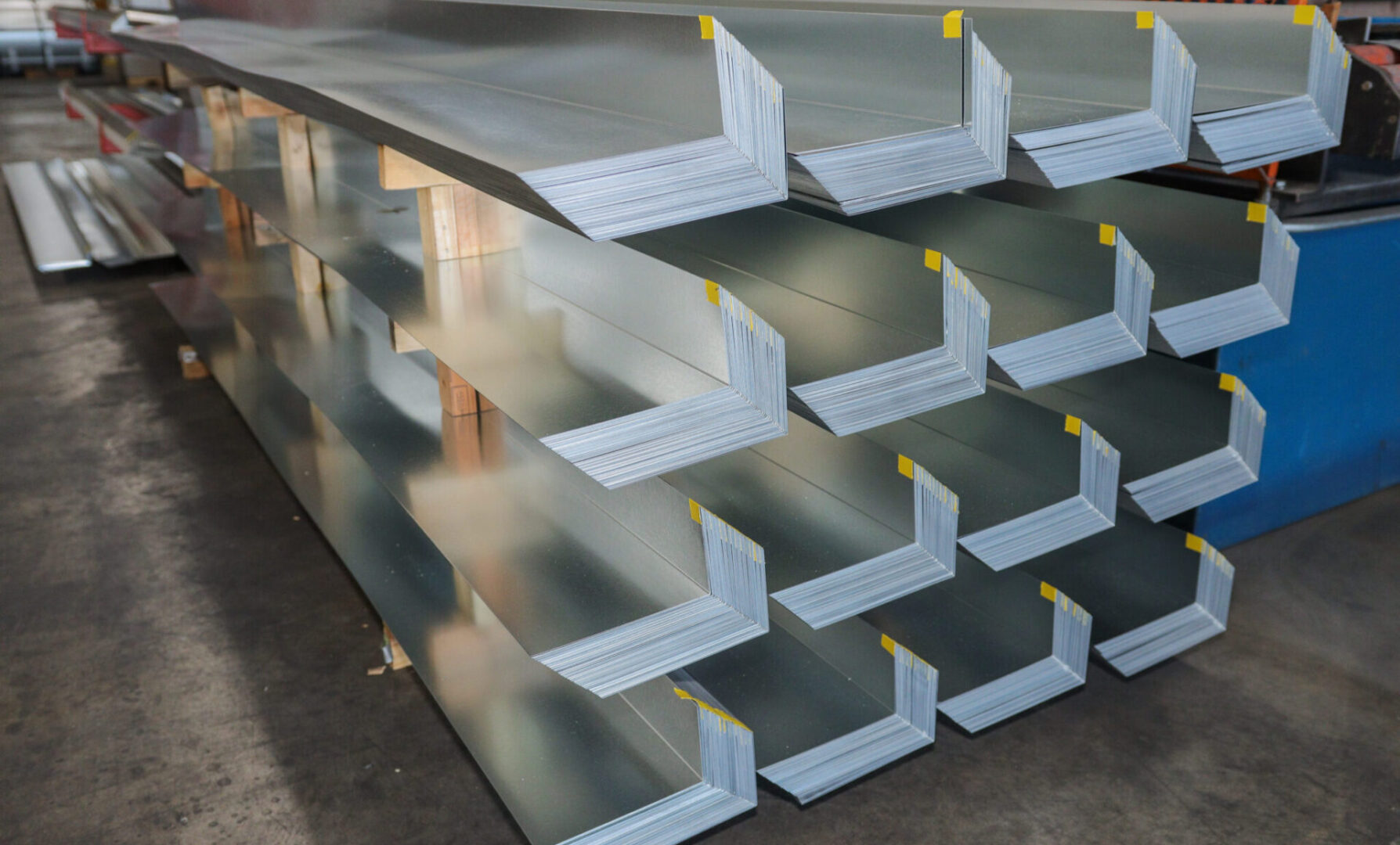 A stack of metal shelves with yellow labels.