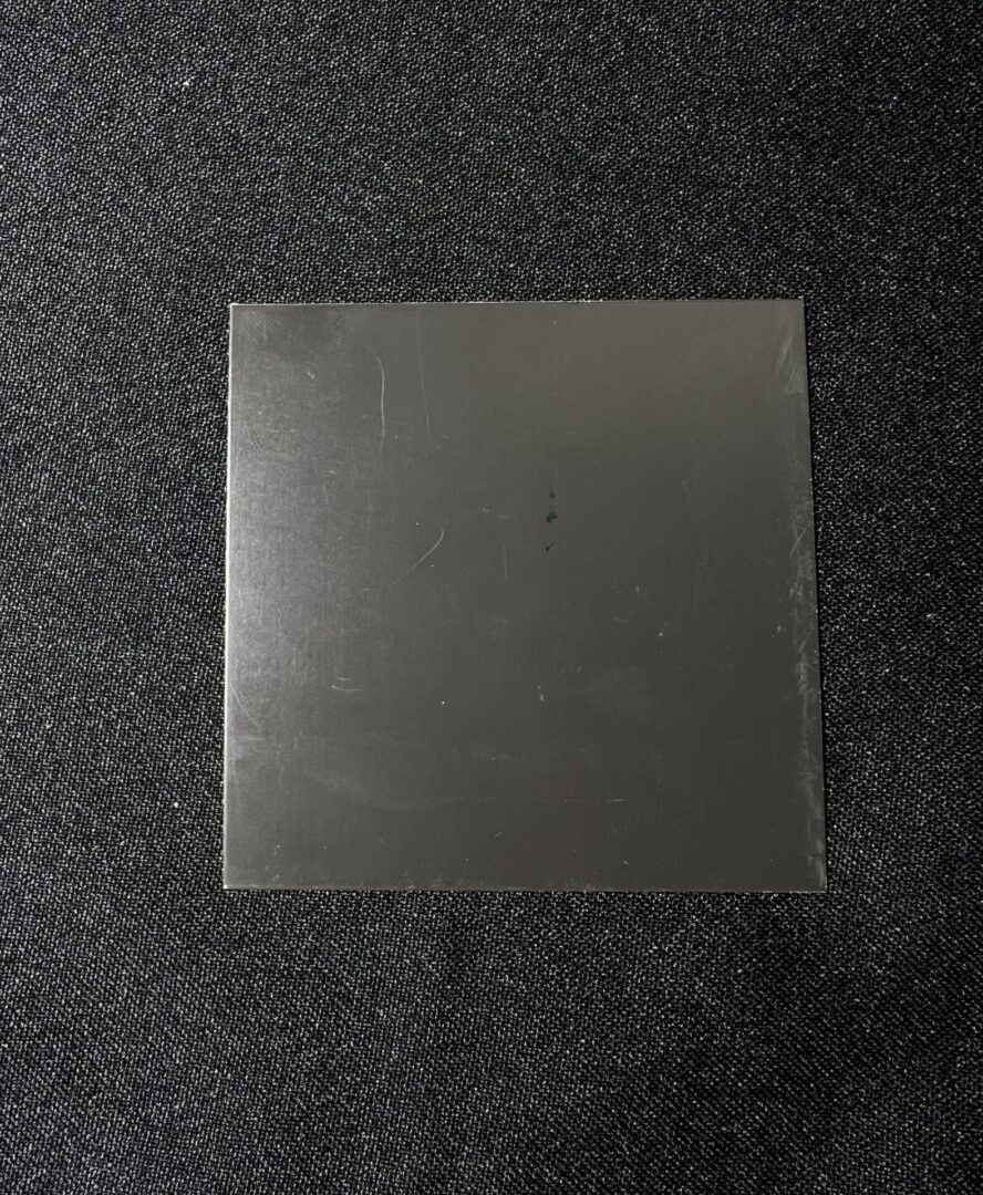 A square piece of plastic sitting on top of the floor.